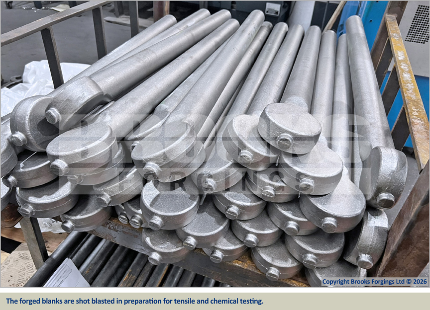 The forged blanks are shot blasted in preparation for tensile and chemical testing