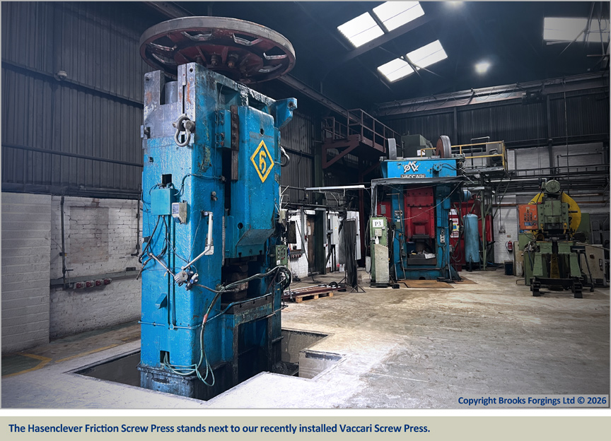 The Hasenclever Friction Screw Press stands next to our recently installed Vaccari Screw Press
