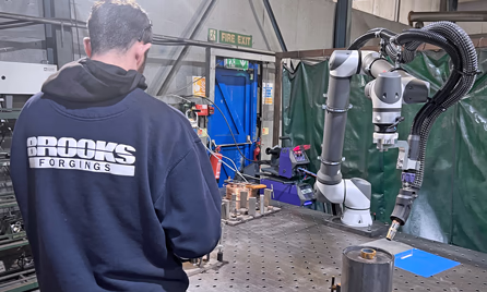 robotic welding arm in operation at Brooks Forgings
